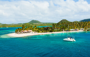 The coast of the island of Martinique in the Caribbean. Yachts, palm trees, beaches and turquoise water. Paradise island of Martinique.