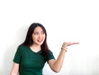 © Reezky - Happy and smile face with smile of young Asian girl in green shirt with hand point on empty space.