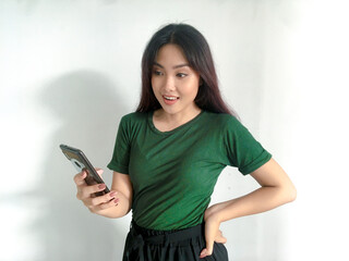 Feeling happy and smile face of Young beautiful asian woman looking on the smartphone. Indonesia women