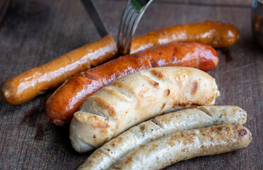 Grilled sausages and mashed potato on wooden boar