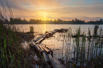 Wall Mural - old wooden fishing pier at sunrise
