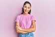 © Krakenimages.com - Hispanic teenager girl with dental braces wearing casual clothes happy face smiling with crossed arms looking at the camera. positive person.