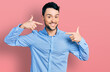 © Krakenimages.com - Hispanic man with beard wearing casual business shirt smiling cheerful showing and pointing with fingers teeth and mouth. dental health concept.