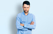 © Krakenimages.com - Hispanic man with beard with arms crossed gesture skeptic and nervous, frowning upset because of problem. negative person.