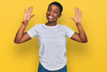 young african american woman wearing casual white t shirt showing and pointing up with fingers numbe