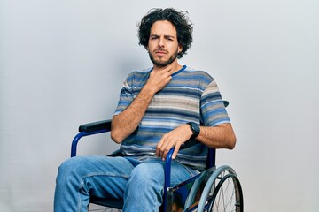 Sticker - Handsome hispanic man sitting on wheelchair touching painful neck, sore throat for flu, clod and infection