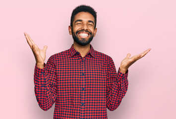 Sticker - Young african american man wearing casual clothes celebrating mad and crazy for success with arms raised and closed eyes screaming excited. winner concept