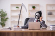© Elnur - Devil businessman employee sitting at workplace