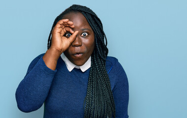 Sticker - Young black woman with braids wearing casual clothes doing ok gesture shocked with surprised face, eye looking through fingers. unbelieving expression.