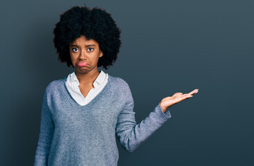 Canvas Print - Young african american woman presenting with open palm depressed and worry for distress, crying angry and afraid. sad expression.