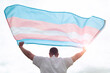 Transgender man holding waving transgender flag, concept picture about human rights, equality in the World