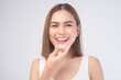 Young smiling woman holding invisalign braces over white background studio, dental healthcare and Orthodontic concept.