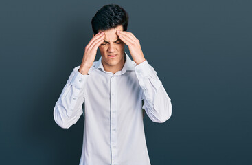 Young hispanic business man wearing business clothes with hand on head for pain in head because stress. suffering migraine.