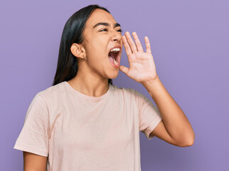 Poster - Young asian woman wearing casual clothes shouting and screaming loud to side with hand on mouth. communication concept.