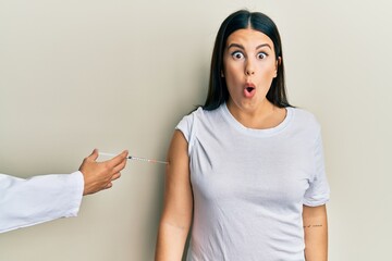 Sticker - Beautiful brunette woman getting vaccine scared and amazed with open mouth for surprise, disbelief face