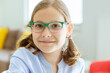 © spass - Portrait of cute little teen girl in glasses with funny pigtails smiling