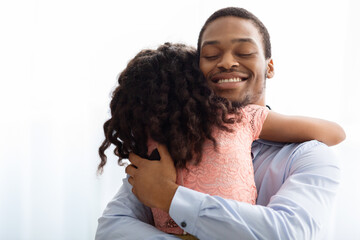 Sticker - Ecstatic african american man hugging his little daughter