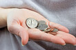 Caucasian woman hand holding and counting usa coin cents. Unemployment, poverty, savings and budget concept.