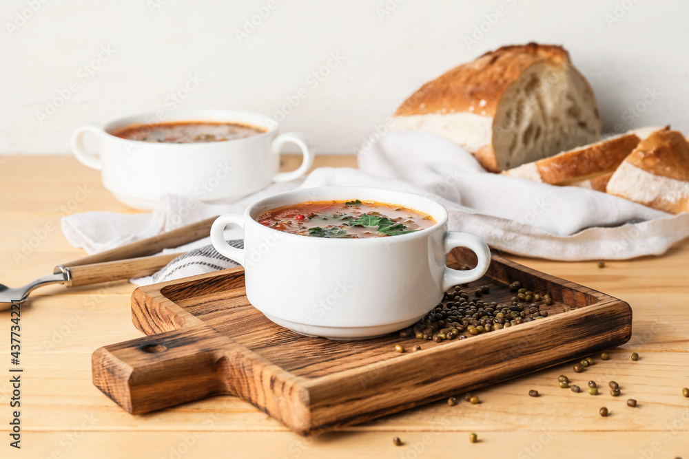 Pot of tasty lentil soup on table