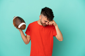 Wall Mural - Young Caucasian man playing rugby isolated on blue background laughing