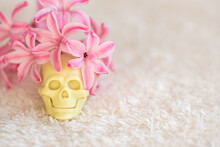 Wonderful Fresh Pink Hyacinths Flowers And Toy Plastic Skull On White Fluffy Fabric Close Upper View Template For Design. Mexican Colorful Scull Day Of Dead Concept.