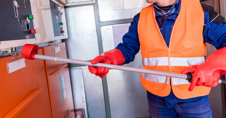 Wall Mural - the engineer checks the absence of induced voltage on the high voltage cells