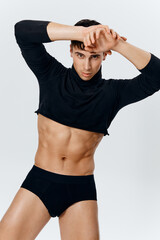 portrait of a young man with hands raised up on a light background cropped view