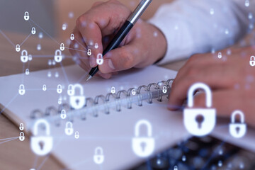 a programmer is taking notes of clients needs to protect cyber security from hacker attacks and save