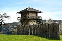 A Reconstructed Wooden Roman Watchtower And A Wooden Border Fence Under A Clear Blue Sky. This Fortification Was Part Of The "Limes", The Border Of The Former Roman Empire.