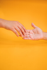 Canvas Print - Vertical shot of the hands of two people outstretched to get in touch