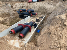 Large Industrial Modern New Large Diameter Polyethylene Plastic Water Pipes Lie In A Pit Underground At A Construction Site During A Water Pipe Repair