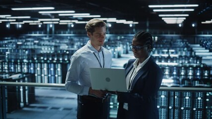Poster - Data Center Female System Administrator and Male IT Specialist talk, Use Laptop. Information Technology Engineers work on Cyber Security Network Protection in Cloud Computing Server Farm. Medium Wide