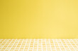 © Sanga - Yellow ceramic mosaic tile table. yellow wall background. Home interior
