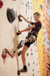 Contemporary disable sportsman going foe sports in wall climbing center