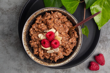 Poster - Chocolate rice porridge with raspberries and almonds. Top view.