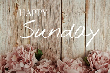 Wall Mural - happy sunday typography text with pink flowers bouquet on wooden background