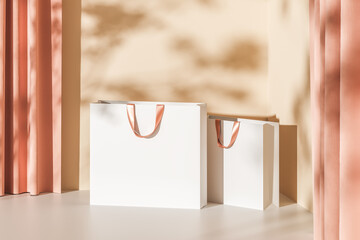 Two white paper bags with pink handles on a beige background with curtains. Mock up. 3d rendering