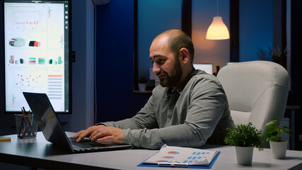 Wall Mural - exhausted businessman working overtime at financial company deadline project. workaholic executive m