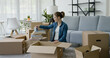 © StockPhotoPro - Young woman unpacking in her new home