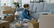 © StockPhotoPro - Woman moving in her new home and connecting with her laptop