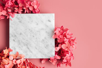 Wall Mural - Square marble plate on pink background with flowers. Stylish background for presentation.