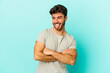 © Asier - Young caucasian man isolated on blue background funny and friendly sticking out tongue.