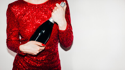 Wall Mural - Festive drink. Holiday celebration. Advertising background. Greeting congrats. Unrecognizable woman holding champagne bottle isolated white copy space.