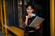 © JustLife - Urban happy woman using digital tablet. Beautiful young woman buying online.