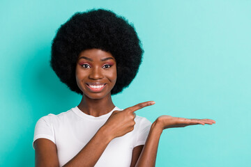 Sticker - Photo of cool short hairdo young lady point hold empty space wear white t-shirt isolated on cyan color background