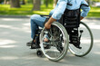Cropped view of young black disabled man in wheelchair enjoying summer at green park, closeup