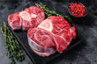 © Vladimir - Raw beef meat osso buco shank steak,  italian ossobuco. Black background. Top view