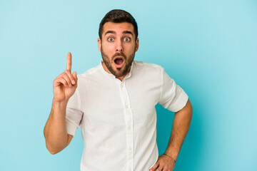 Wall Mural - Young caucasian man isolated on blue background having an idea, inspiration concept.