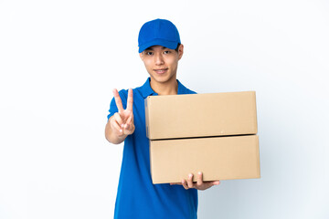 Delivery Chinese man isolated on white background smiling and showing victory sign