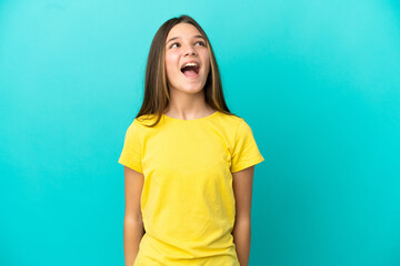 Little girl over isolated blue background laughing